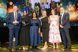 Six members of the Fiona Stanley Hospital Geriatricians for Older Adults in the Emergency Department team stand onstage to accept a WA Health Excellence Award