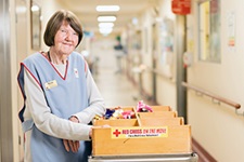 Murray District Hospital volunteer Marie Paterson stands beside a trolley of items for hospital patients.