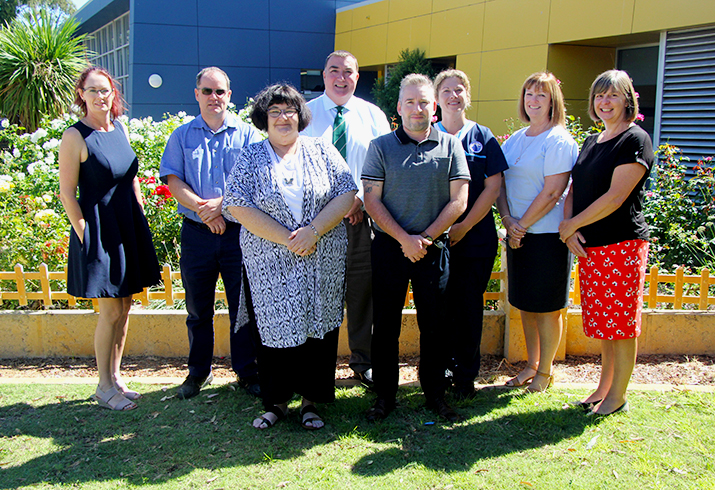 Eight members of the Rockingham General Hospital Environmental Sustainability Special Interest Group standing in a garden.