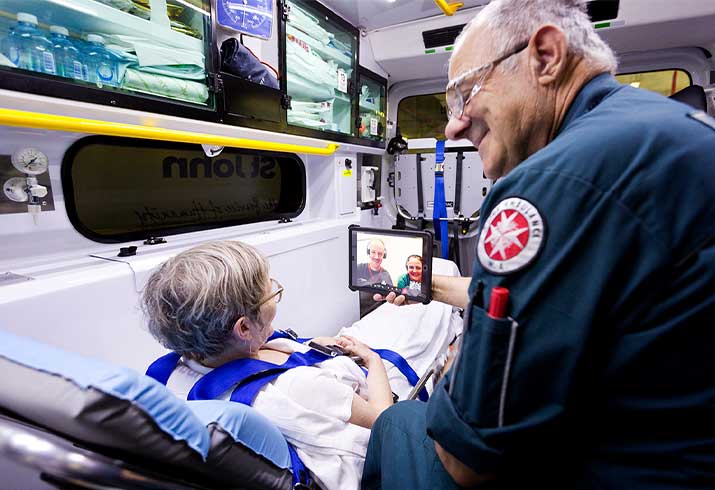 Paramedic shows patient video call in the back of ambulance.