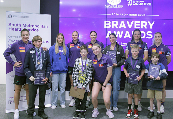 Members of the Fremantle Dockers stand with a group on children at the 2024 A.J Diamond Club Fremantle Dockers’ Bravery Awards