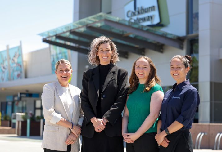 Four women involved in the Cockburn Gateway smoke free project standing in front of the shopping centre.