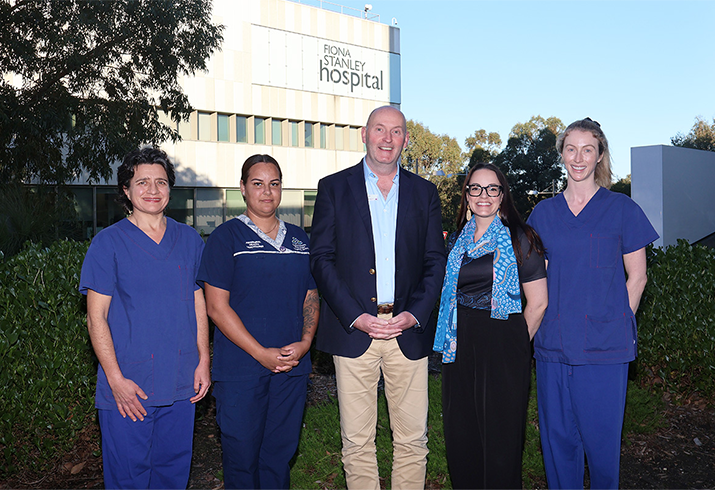 Dr Agneta Geldenhuys, Aboriginal Health Practitioner Liana Prosser, SMHS Chief Executive Neil Doverty, Nurse Educator Lucy Soteriou and Registrar Molly Gilfillan all standing together, with Fiona Stanley Hospital signage in the background behind them. 