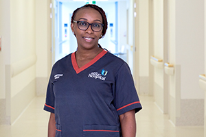 Elizabeth Gatonga stands in a hospital corridor